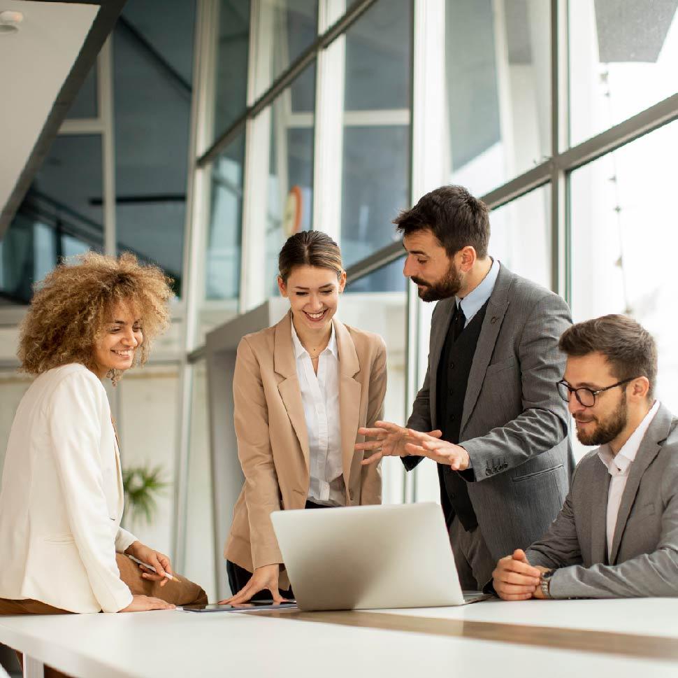 group of people around conference table looking at a computer