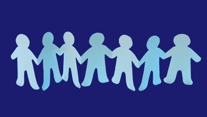 Row of light blue paper cutout figures holding hands against a dark blue background.